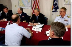 President George W. Bush and Secretary of Homeland Security Tom Ridge, far right, meet with U. S. Coast Guard officers during their visit to the port in Philadelphia Monday, March, 31, 2003.  White House photo by Tina Hager