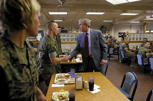 President George W. Bush greets Marines before sitting down with them for lunch at Camp Lejeune in Jacksonville, N.C., Thursday, April 3, 2003. White House photo by Paul Morse