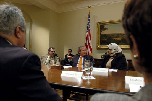 President George W. Bush talks with Zainab Al-Suwaij during a meeting with Iraqi-Americans and free Iraqis who are living in the United States in the Roosevelt Room Friday, April 4, 2003. President of the American Islamic Congress, Ms. Al-Suwaij was born in Southern Iraq and participated in the 1991 uprising against Saddam Hussein before escaping to America. White House photo by Eric Draper.