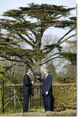 President George W. Bush and British Prime Minister Tony Blair talk alone in the gardens of Hillsborough Castle near Belfast, Northern Ireland, Tuesday, April 8, 2003.  White House photo by Paul Morse