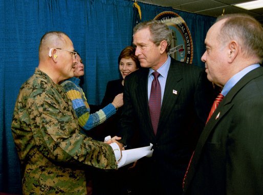 President George W. Bush and Laura Bush attend the U.S. Citizenship Ceremony for Marine Corps Mastery Gunnery Sgt. Guadalupe Denogean of Tucson, Ariz., at the National Naval Medical Center in Bethesda, Md., Friday, April 11, 2003. Pictured at far right, Eduardo Aguirre, Jr., Acting Director of the Bureau of Citizenship and Immigration Services, conducted the ceremony. White House photo by Eric Draper