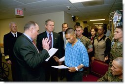 President George W. Bush attends the U.S. Citizenship Ceremony for Marine Corps Lance Cpl. O.J. Santamaria of Daly City, Calif., at the National Naval Medical Center in Bethesda, Md., Friday, April 11, 2003.  White House photo by Eric Draper