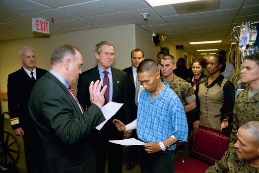 President George W. Bush attends the U.S. Citizenship Ceremony for Marine Corps Lance Cpl. O.J. Santamaria of Daly City, Calif., at the National Naval Medical Center in Bethesda, Md., Friday, April 11, 2003. White House photo by Eric Draper