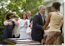 President George W. Bush greets Tamara Brooks after signing the S. 151, PROTECT Act of 2003, in the Rose Garden Wednesday, April 30, 2003. Brooks, 17, was rescued after an AMBER Alert was issued throughout Orange County, Calif., alerting the community of her abduction. Donna Norris, left, embraces her son Ricky after the bill signing. The AMBER Alert system is named in honor of her 9-year-old daughter, Amber Hagerman, who was abducted while playing near her Arlington, Texas, home and later found murdered.   White House photo by Paul Morse