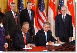 President George W. Bush and Singapore Prime Minister Chok Tong Goh sign a free trade agreement in the East Room Tuesday, May 6, 2003.  White House photo by Tina Hager