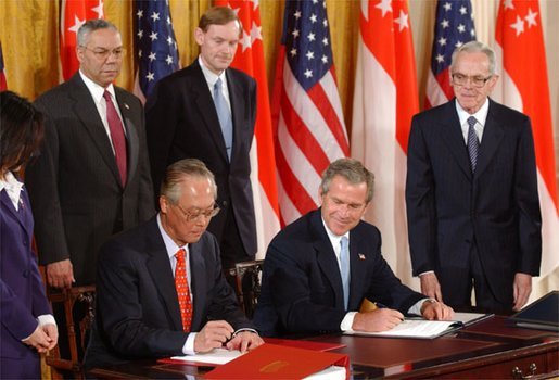 President George W. Bush and Singapore Prime Minister Chok Tong Goh sign a free trade agreement in the East Room Tuesday, May 6, 2003. White House photo by Tina Hager