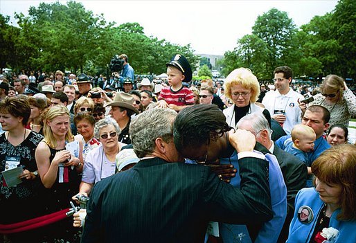 President George W. Bush comforts a woman during the Annual Peace Officers' Memorial Service at the U.S. Capitol in Washington, D.C., Thursday, May 15, 2003. 