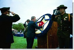 President George W. Bush places a flower on a memorial wreath during the Annual Peace Officers Memorial Service at the U.S. Capitol Washington, D.C., Thursday, May 15, 2003.  White House photo by Paul Morse