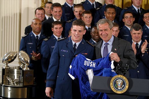 President George W. Bush receives a jersey during the presentation of the Commander-in-Chief's Trophy in the East Room Friday, May 16, 2003. "I'm proud to welcome back to the White House the Air Force Academy Falcons, who have now won the Commander-in-Chief's Trophy for their six consecutive year, and 16th time overall," said the President in his remarks. White House photo by Paul Morse
