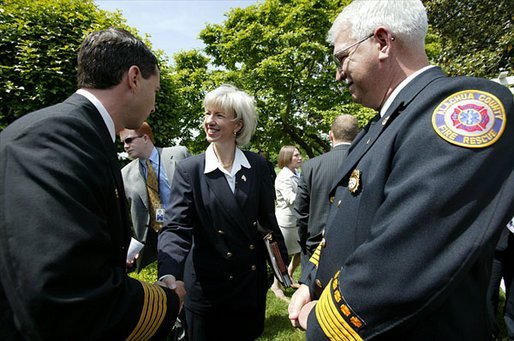 Interior Secretary Gale Norton greets firefighters after the President's remarks on his Healthy Forests Initiative in The East Garden Tuesday, May 20, 2003. White House photo by Susan Sterner.