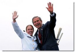 After receiving her degree from President George W. Bush, a cadet and the President wave to the gathered crowd during the United States Coast Guard Academy Commencement in New London, Conn., Wednesday, May 21, 2003.  White House photo by Eric Draper