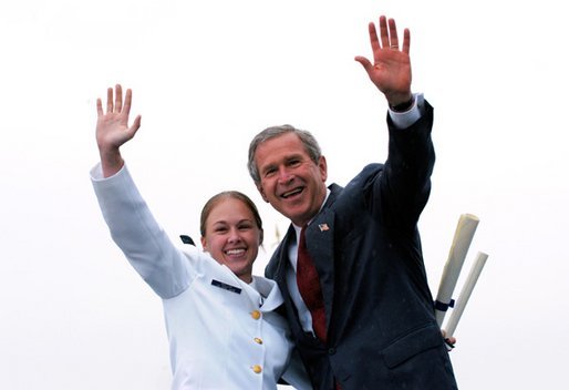 After receiving her degree from President George W. Bush, a cadet and the President wave to the gathered crowd during the United States Coast Guard Academy Commencement in New London, Conn., Wednesday, May 21, 2003. White House photo by Eric Draper.