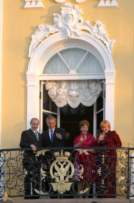 President George W. Bush and Mrs. Laura Bush wave with Russian President Vladimir Putin and wife Lyudmila Putin from the window of Peterhof Palace in St. Petersburg, Russia May 31, 2003. They were taking part in St. Petersburg's 300th anniversary celebration. White House photo by Paul Morse