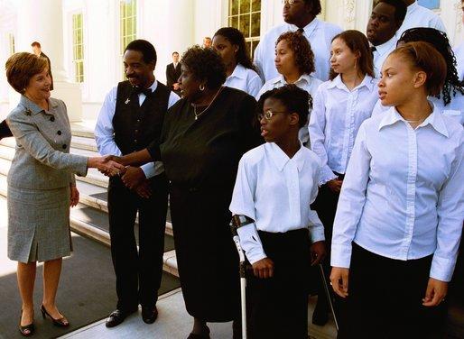 Laura Bush greets Dr. Blanche Hammond and members of the D.C. High School Choral Group Monday, June 9, 2003. The group performed during, "The White House: In Tune With History," a program celebrating the history of live music performances at the White House. White House photo by Susan Sterner