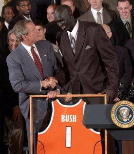 Congratulating the NCAA Winter Championship teams, President George W. Bush stands with Kueth Duany of Syracuse University's mens' basketball team in the East Room Tuesday, June 17, 2003.  White House photo by Tina Hager