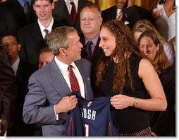 Congratulating the NCAA Winter Championship teams, President George W. Bush stands with Diana Taurasi of the University of Connecticut's women's basketball team in the East Room Tuesday, June 17, 2003.  White House photo by Tina Hager