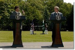 Presidents Pervez Musharraf of Pakistan and George W. Bush hold a joint press conference at Camp David Tuesday, June 24, 2003. "Greater economic development is also critical to fulfilling the hopes of the Pakistani people," said President Bush. "Since we met last year, the United States has cancelled $1 billion of debt Pakistan owed our country. And today I'm pleased to announce that our nations are signing a trade and investment framework agreement, which creates a formal structure for expanding our economic partnership."  White House photo by David Bohrer