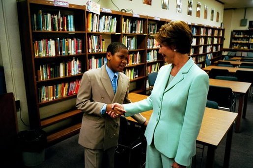 Laura Bush meets a student as she tours the library of Dimner Beeber Middle School in Philadelphia, Pa., June 25, 2003. White House photo by Tina Hager