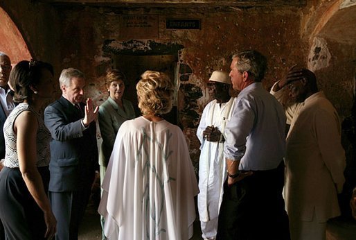 President George W. Bush and Laura Bush tour the Slave House on Goree Island, Senegal, with President Abdoulaye Wade and Viviane Wade of Senegal, Secretary of State Colin Powell, far left, and National Security Advisor Dr. Condoleezza Rice Tuesday, July 8, 2003. White House photo by Paul Morse.