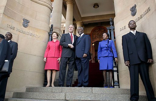 President George W. Bush and Laura Bush are welcomed to the Union House in Pretoria, South Africa, by South African President Thabo Mbeki and Zanele Mbeki Wednesday, July 9, 2003. White House photo by Paul Morse
