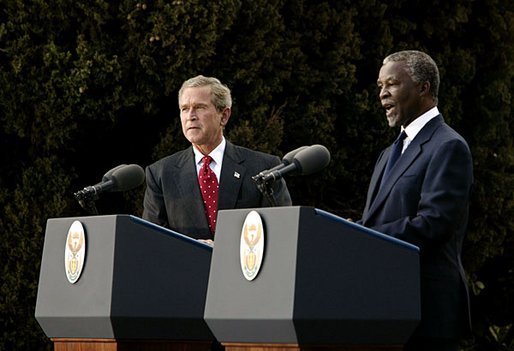 Presidents Bush and Mbeki speak to the media at the Guest House in Pretoria, South Africa, Wednesday, July 9, 2003. “I must say, President (Bush), that at the end of these discussions, we, all of us, feel enormously strengthened by your very, very firm and clear commitment to assist us to meet the challenges that we've got to meet domestically and on the African continent,” said President Mbeki. White House photo by Paul Morse