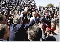 President George W. Bush greets an eager crowd upon his arrival at Sir Seretse Khama International Airport in Gaborone, Botswana, Thursday, July 10, 2003. 