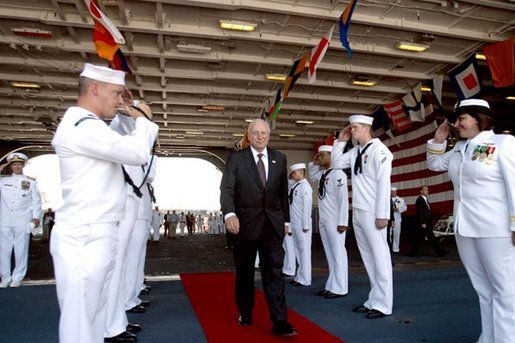 Sailors salute Vice President Dick Cheney as he departs the USS Ronald Reagan after the aircraft carrier's commissioning ceremony at the Norfolk Naval Station in Norfolk, Va., July 12, 2003.  White House photo by David Bohrer.