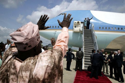 Nigerian President Olesugun Obasanjo waves to President Bush and Laura Bush as they depart from Abuja, Nigeria on July 12, 2003 White House photo by Paul Morse.