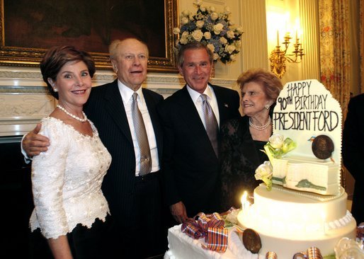 President George W. Bush and Laura Bush pose with former President Gerald R. Ford and wife Betty Ford during the presentation of the birthday cake at the Dinner in Honor of President Ford's 90th Birthday at the White House, Wednesday, July 16, 2003. White House photo by Eric Draper.