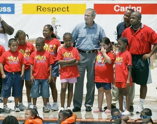 President George W. Bush views swimming pool activities of children during a tour of Lakewest Family YMCA in Dallas, Texas, Friday, July 18, 2003. White House photo by Eric Draper