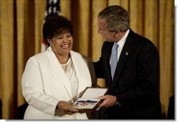 Vera Clemente accepts the Presidential Medal of Freedom from President George W. Bush on behalf of her husband Roberto Clemente Walker during a ceremony in the East Room Wednesday, July 23, 2003. A Hall of Fame baseball player, Mr. Clemente was committed to helping the less fortunate. The medal is the highest civilian award.   White House photo by Paul Morse