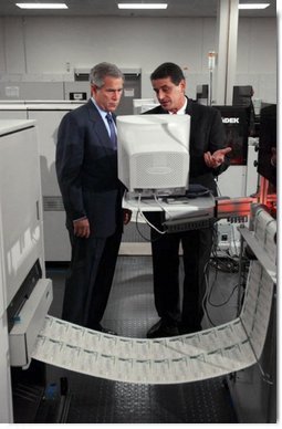 President George W. Bush and regional director Mike Colarusso tour the Department of the Treasury's Philadelphia Financial Management Service Facility July 24, 2003.  White House photo by Tina Hager