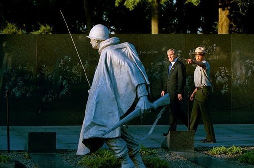 President George W. Bush and U.S. Park Ranger Lance Hatten tour the Korean War Veterans Memorial in Washington, D.C., Friday, July 25, 2003. Marking the 50th anniversary of the signing the armistice that ended the Korean war July 27, 1953, President Bush visited the memorial to honor those who served in the conflict. White House photo by Paul Morse.