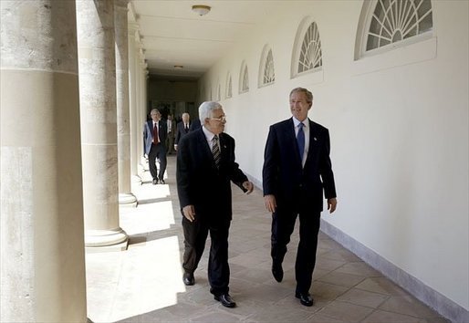 President George W. Bush and Palestinian Prime Minister Mahmoud Abbas walk along the colonnade after their joint press conference in the Rose Garden Friday, July 25, 2003. Meeting for the first time at the White House, the two leaders held a working lunch and a meeting in the Oval Office. White House photo by Paul Morse.