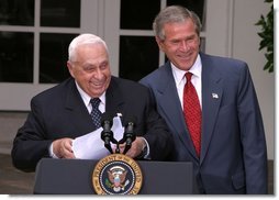 President George W. Bush and Israeli Prime Minister Ariel Sharon laugh together during their joint press conference in the Rose Garden Tuesday, July 29, 2003.  White House photo by Paul Morse