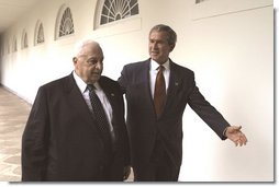 President George W. Bush and Israeli Prime Minister Ariel Sharon walk through the Rose Garden colonnade after their joint press conference Tuesday, July 29, 2003.  White House photo by Paul Morse