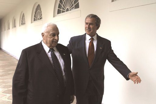 President George W. Bush and Israeli Prime Minister Ariel Sharon walk through the Rose Garden colonnade after their joint press conference Tuesday, July 29, 2003. White House photo by Paul Morse.