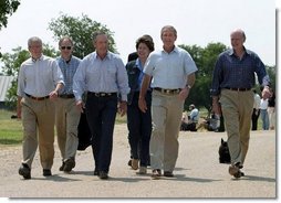 After talking with the press, President George W. Bush walks with his economic advisors at his ranch in Crawford, Texas, Wednesday, August 13, 2003. Pictured are, from left, Director of the Office of Management and Budget Josh Bolten, Assistant to the President for Economic Policy Stephen Friedman, Secretary of Commerce Don Evans, Secretary of Labor Elaine Chao and Secretary of the Treasury John Snow.   White House photo by Susan Sterner