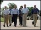 After talking with the press, President George W. Bush walks with his economic advisorsat his ranchin Crawford, Texas, Wednesday, August 13, 2003. Pictured are, from left,Director of the Office of Management and Budget Josh Bolten, Assistant to the President for Economic Policy Stephen Friedman, Secretary of Commerce Don Evans, Secretary of Labor Elaine Chao and Secretary of the Treasury John Snow.  White House photo by Susan Sterner