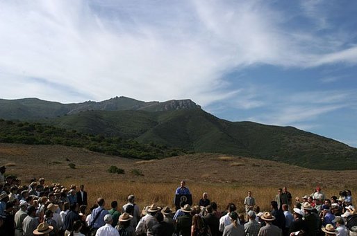 As hills in the Santa Monica Mountains National Recreation Area roll through the landscape, President George W. Bush delivers remarks with Secretary of the Interior Gale Norton in Thousand Oaks, Calif. File photo. White House photo by Paul Morse.