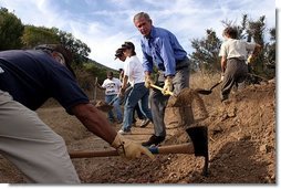 Working alongside volunteers, President George W. Bush lends a hand in repairing the Old Boney Trail at the Santa Monica Mountains National Recreation Area in Thousand Oaks, Calif. File photo.  White House photo by Paul Morse