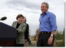 President George W. Bush is introduced by Secretary of Agriculture Ann Veneman before discussing his healthy forest initiative in Redmond, Ore., Thursday, August 21, 2003. Secretary of the interior Gale Norton is pictured in the background.  White House photo by Paul Morse