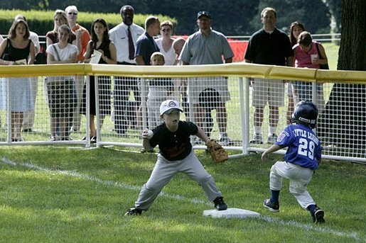 The first basemen from the Hamilton Little Lads Cal Ripken League of Hamilton, N.J., makes a play during a fast-paced game against the Milwood Little League of Kalamazoo, Mich., during the last game of the 2003 White House South Lawn Tee Ball season Sunday, Sept. 7, 2003. White House photo by Lynden Steele.