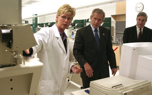 President George W. Bush and FBI Director Robert Mueller watch as chemist Eileen Waninger, left, demonstrates a TSQ - 1 ThermoFinnigan Triple Stage Quadruple GC/MS instrument during a tour of the new FBI Laboratory in Quantico, Va., Wednesday, Sept. 10, 2003. The TSQ-1 has been used to identify chemical components for the Embassy bombings in Africa, attack on USS Cole and the bombing of United Nations in Iraq. White House photo by Paul Morse