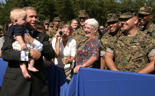 President George W. Bush holds 7-month-old Frank Antonelli, whose father is a major in the Marine corps, as he greets workers at the FBI Academy in Quantico, Va., Wednesday, Sept. 10, 2003. White House photo by Paul Morse