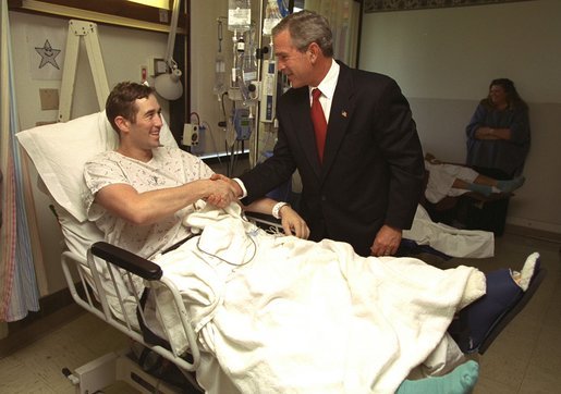 President George W. Bush shakes hands with Staff Sgt. Ethan Craig of Chester, Mass., after awarding him The Purple Heart at Walter Reed Army Medical Center Thursday, Sept. 11, 2003. Visiting with patients who were injured while serving in Operation Iraqi Freedom, President Bush awarded 11 Purple Hearts. White House photo by Paul Morse.