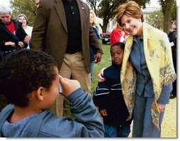 Mrs. Bush poses with children during her visit to the 2003 National Book Festival on the National Mall in Washington, D.C., Oct. 4, 2003.  White House photo by Susan Sterner