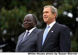 Presidents Bush and Kibaki watch the military review portion of the State Arrival Ceremonies on the South Lawn of the White House Monday, October 5, 2003. White House photo by Susan Sterner. White House photo by Susan Sterner
