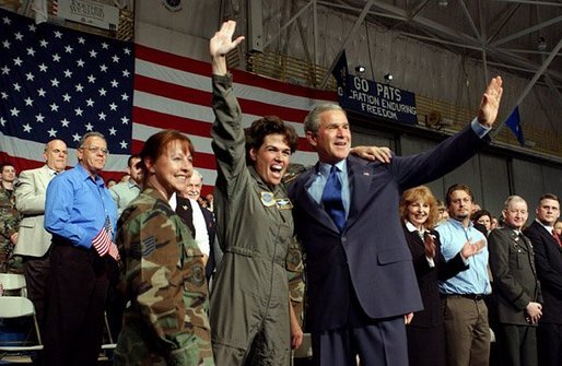 President George W. Bush is welcomed by a member of the New Hampshire Air National Guard at Pease Air National Guard Base in Portsmouth, N.H., Thursday, Oct. 9, 2003. White House photo by Tina Hager