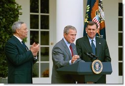 President George W. Bush discusses America's policies regarding Cuba as Secretary of State Colin Powell, left, and Secretary of Housing and Urban Development Mel Martinez stand by his side in the Rose Garden Friday, Oct. 10, 2003. "We will increase the number of new Cuban immigrants we welcome every year," said the President. "We are free to do so, and we will, for the good of those who seek freedom. Our goal is to help more Cubans safely complete their journey to a free land."  White House photo by Tina Hager